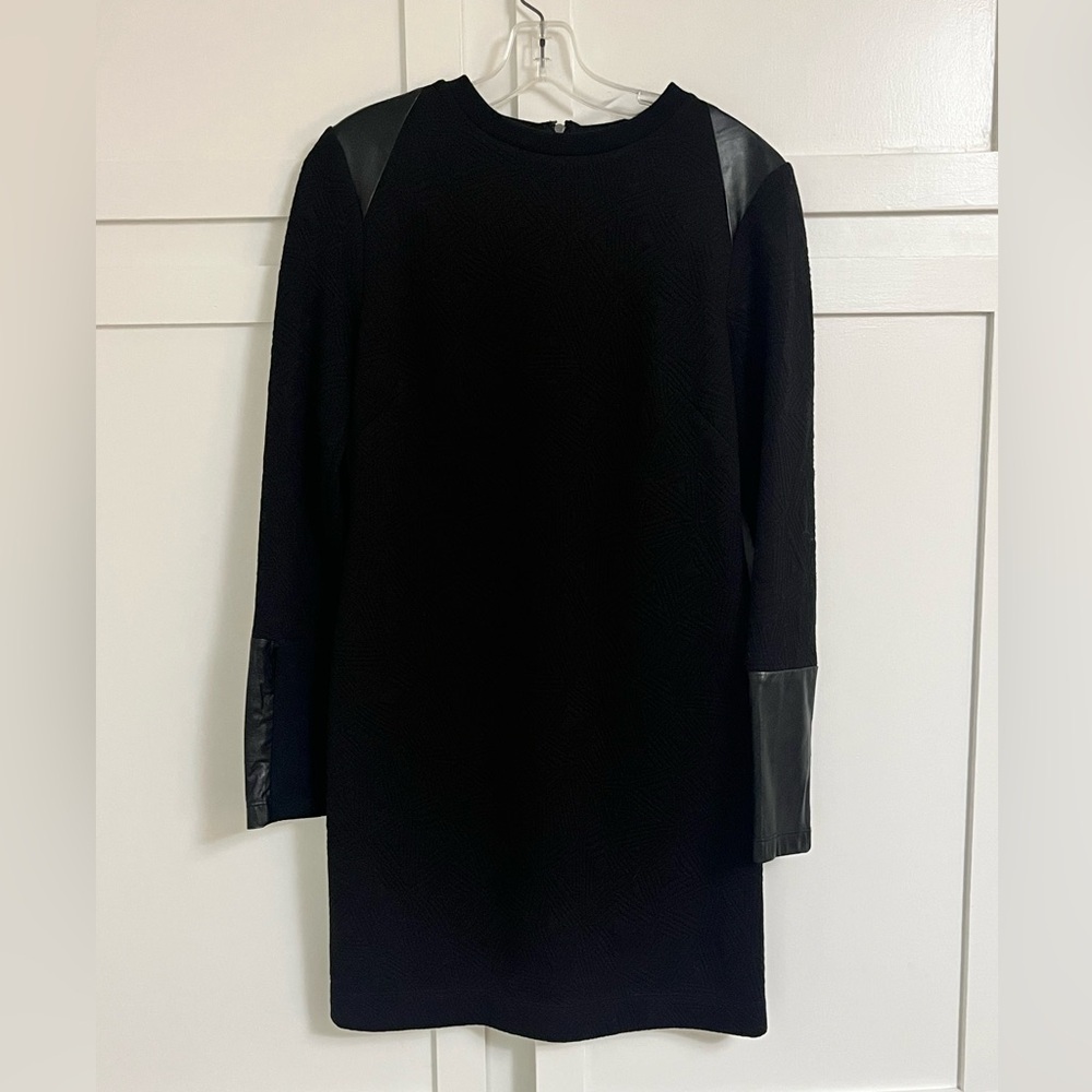 Nicole Miller black dress with leather accents on shoulders and arms. Size 8